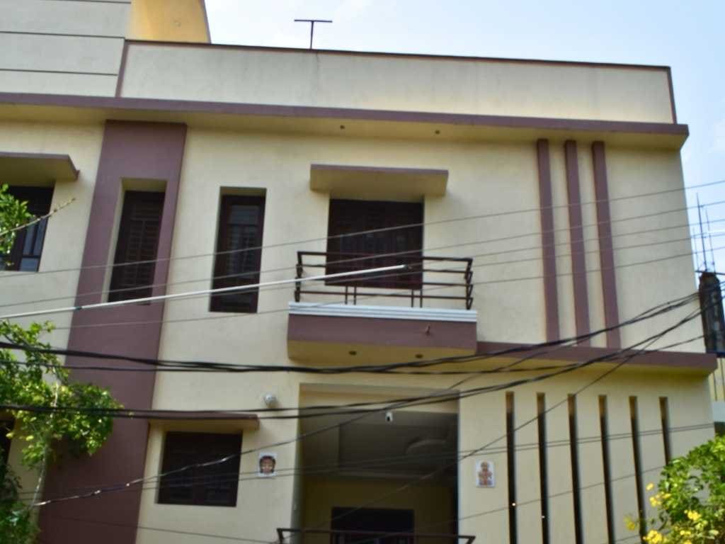 Front elevation of Skandanam Ecoville Homestay with its signboard