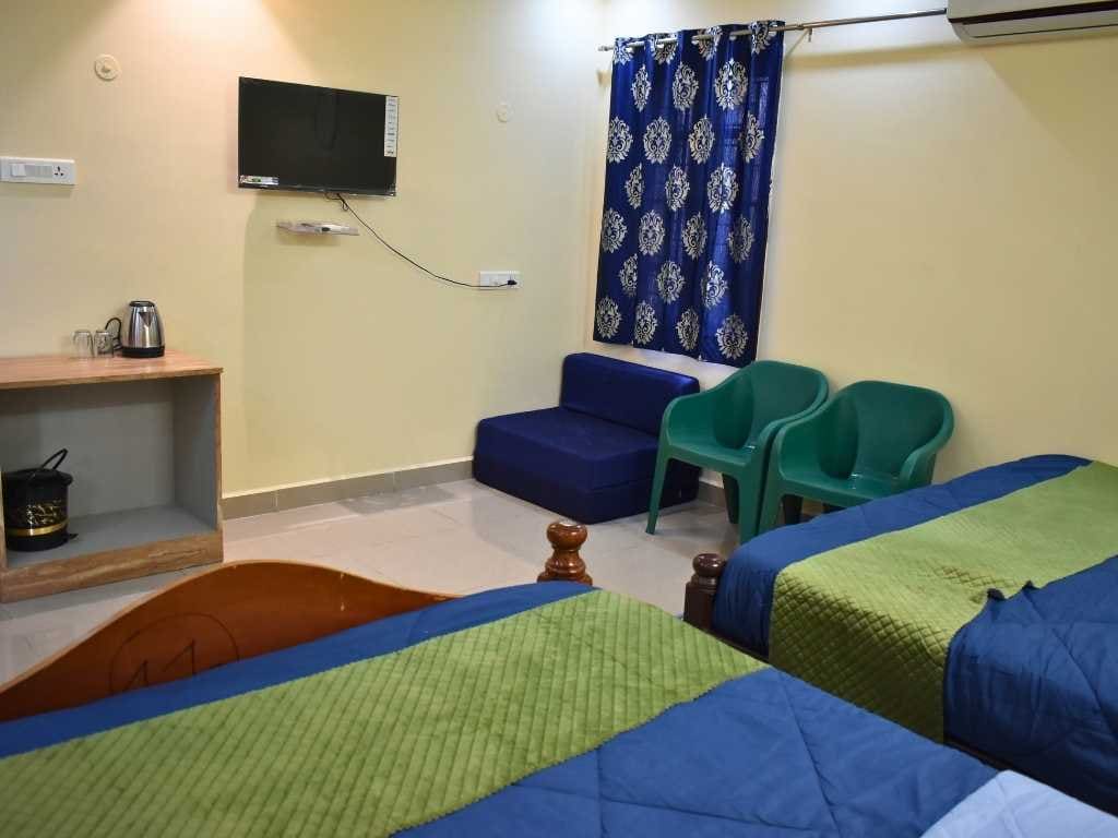 Two king-size beds in the Premium Family Suite at Skandanam Ecoville